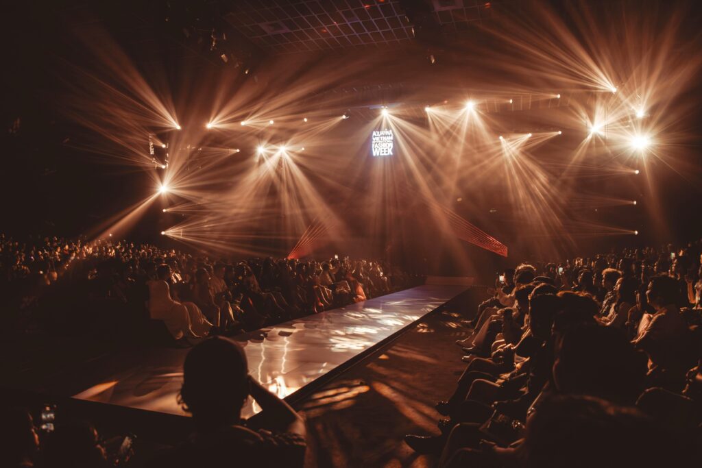 Exciting fashion show event with dazzling lights and a captivated audience.